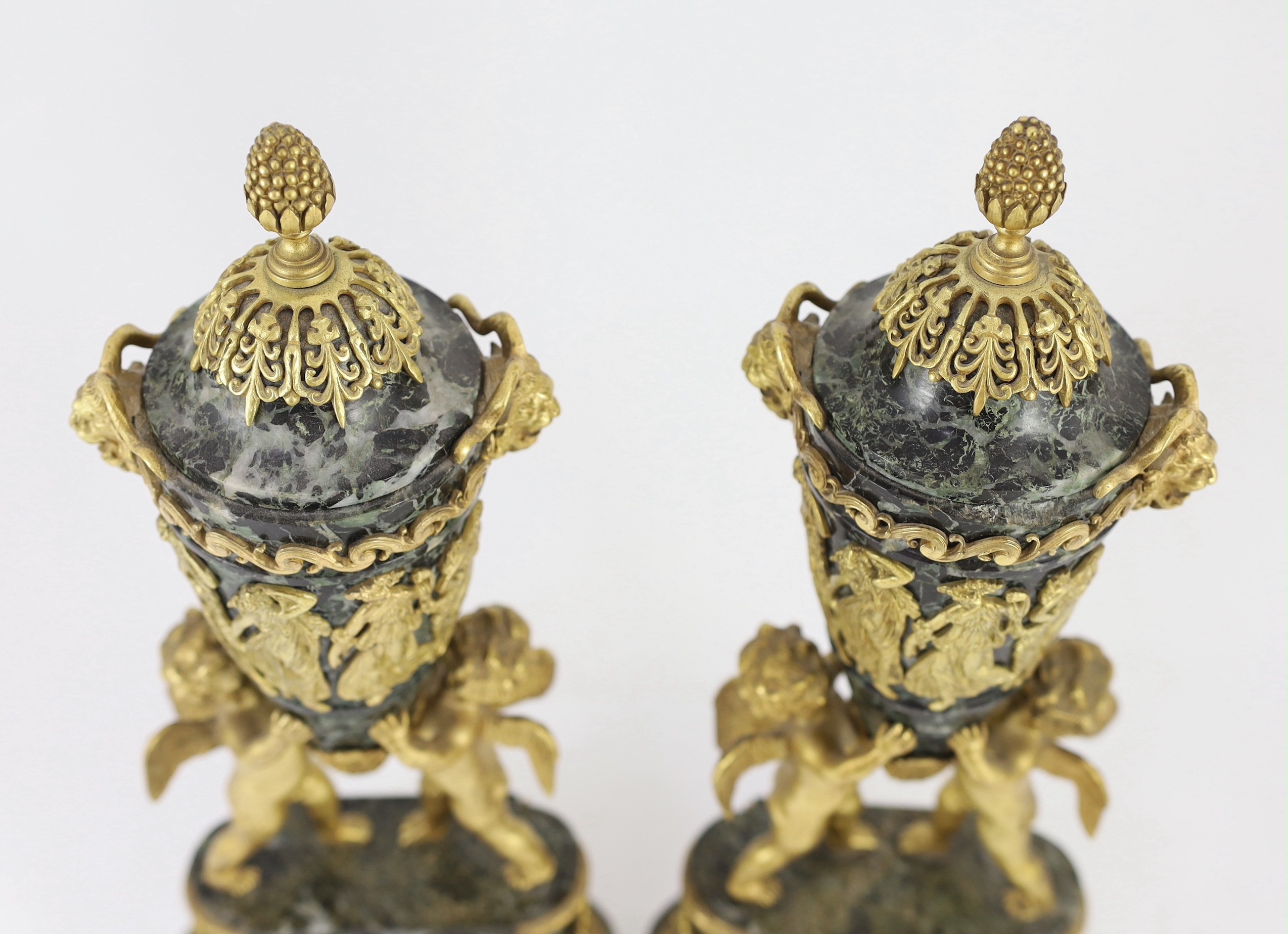 A pair of Louis XVI style ormolu mounted green marble urns Height 41cm.